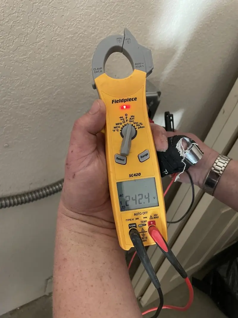 Voltage testing with clamp meter during Electrical Installation Services in Rindge